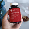 Neurogan Health CoEnzyme Q10 capsules in a bottle, showing the supplement's label and a few capsules outside the bottle.