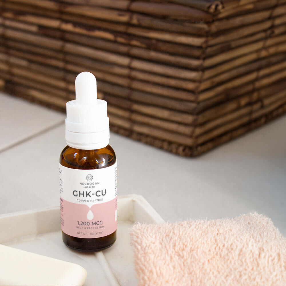 Neurogan Health GHK-Cu Copper Peptide Neck and Face Serum bottle with serum applicator on a skincare table.