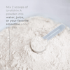 Neurogan Health Urolithin A Powder supplement in a clear glass jar with a scoop, displayed on a neutral background.